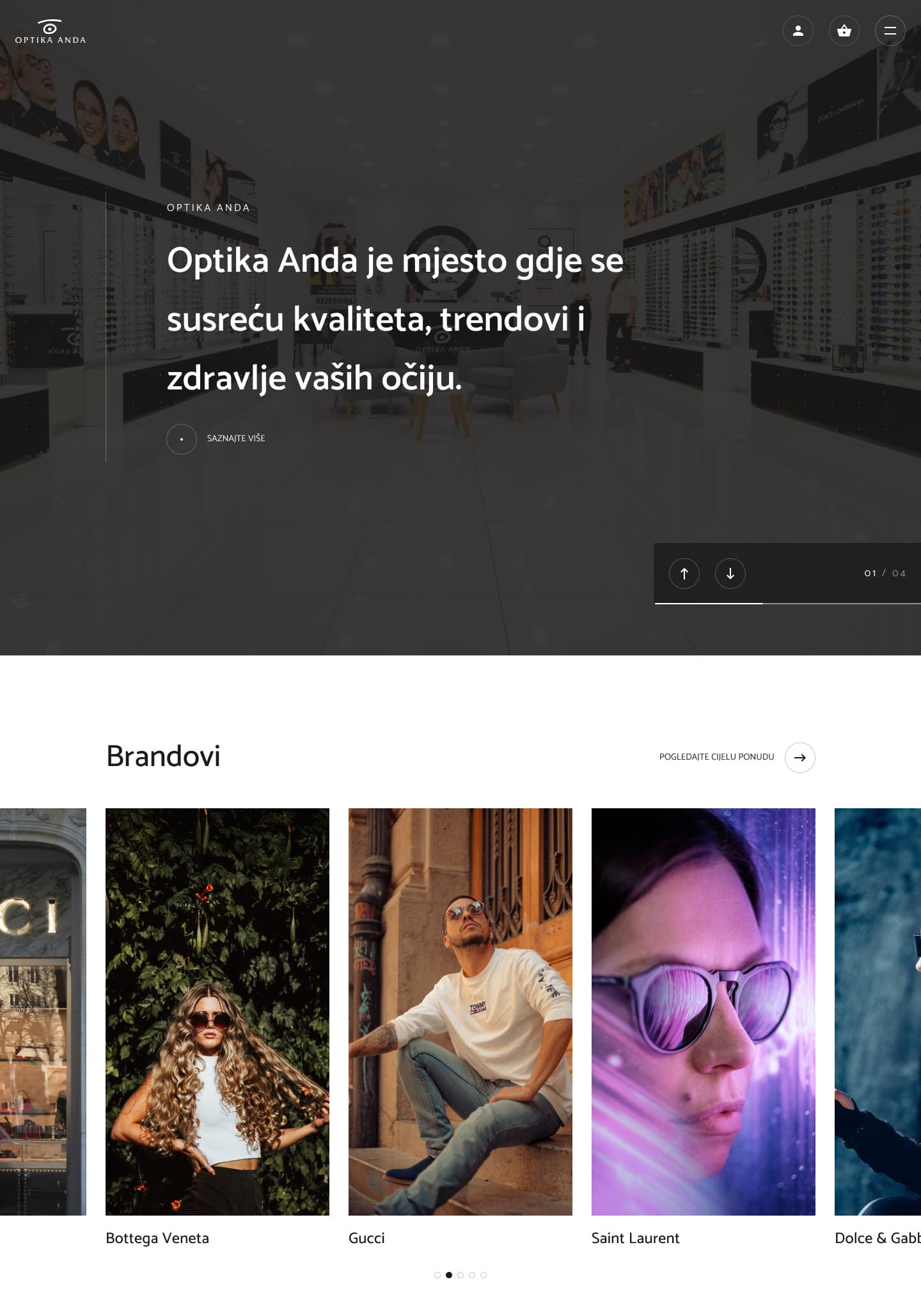Optika Anda homepage hero showing an eyewear store interior with a brand showcase featuring Bottega Veneta, Gucci, and Saint Laurent